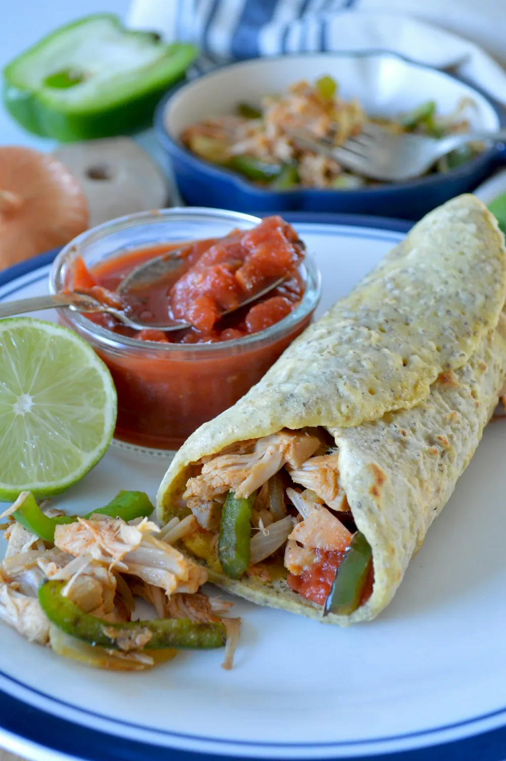 Burrito cut in half with salsa and lime