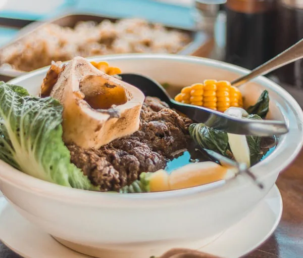 Beef soup with corn and a bone